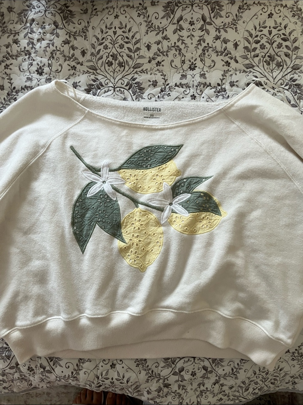 Hollister Off-the-Shoulder Cream Sweatshirt with Yellow Lemon Appliqué
